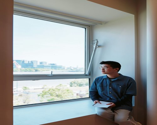 Person looking out of a window, taking a break from work