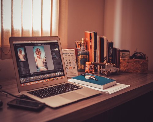 A person working from home, looking at a computer screen